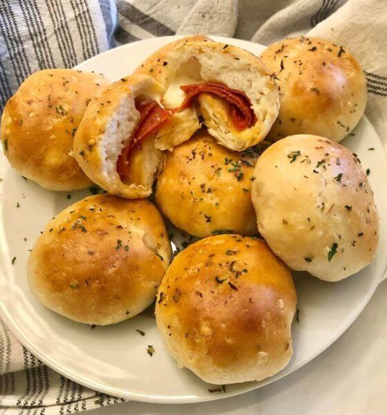 Pepperoni and cheese in rolls on white plate