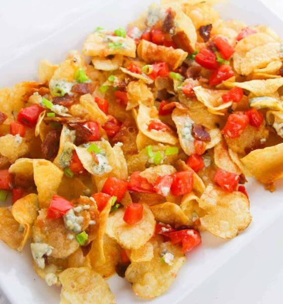 Cheesy nachos on white plate