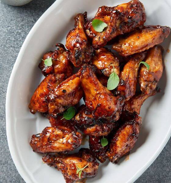 Barbecue air fryer chicken wings on white plate.