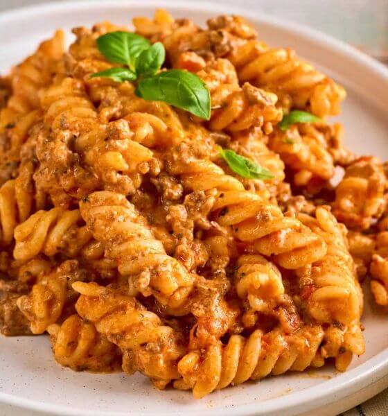 Creamy beef pasta on white plate