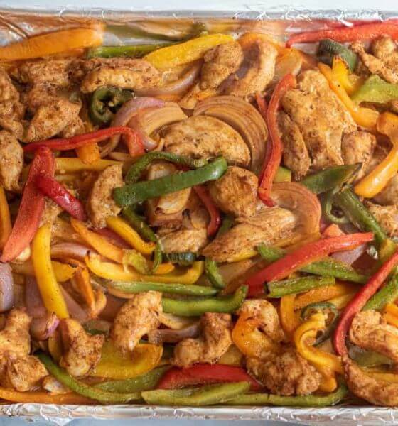 Chicken fajitas with peppers and onions on a sheet pan