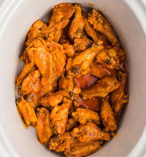 Buffalo chicken wings in white slow cooker