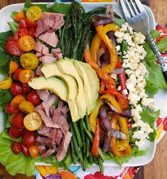 Ham and asparagus cobb salad on white dish for spring