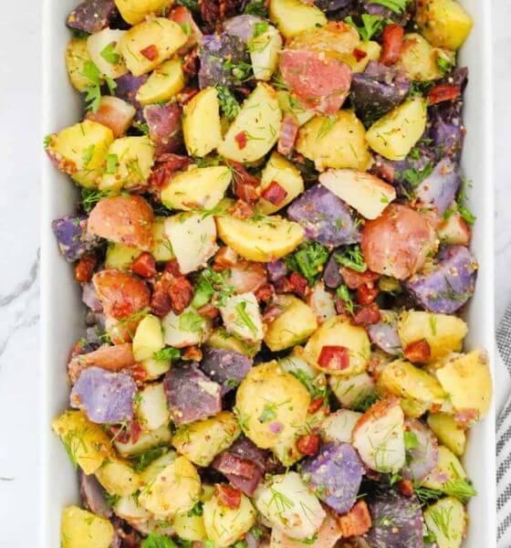 Potato salad and bacon without mayo in white dish