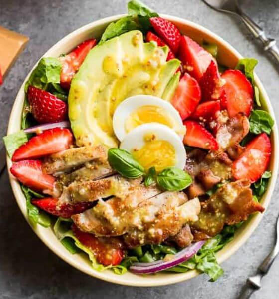 Strawberry cobb salad for spring in white bowl