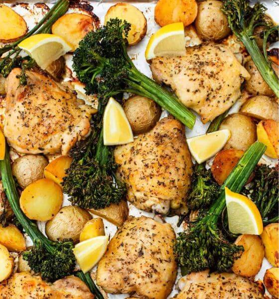 Chicken, broccoli, lemons, and potatoes on a sheet pan