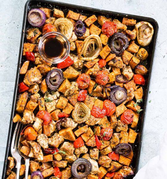 Ranch chicken and vegetables on a baking sheet