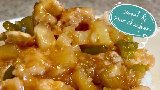 sweet and sour chicken over rice on white plate