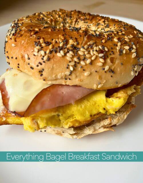 Bagel breakfast sandwich on white plate with text in a blue strip