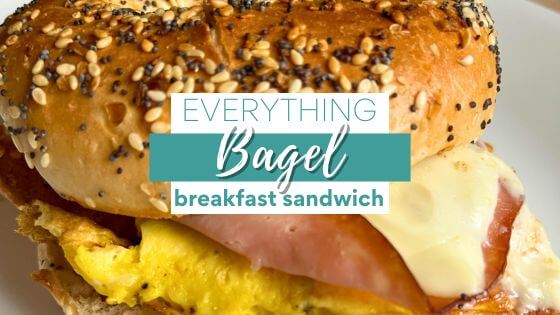 Breakfast sandwich on white plate with eggs, ham and cheese with text