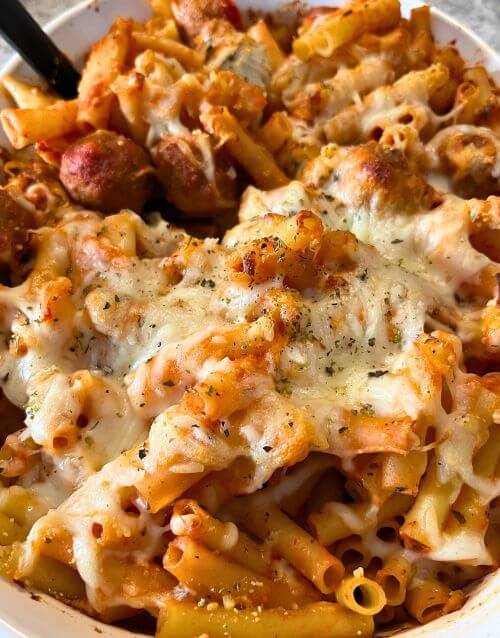 Picture of baked ziti and meatballs in white dish