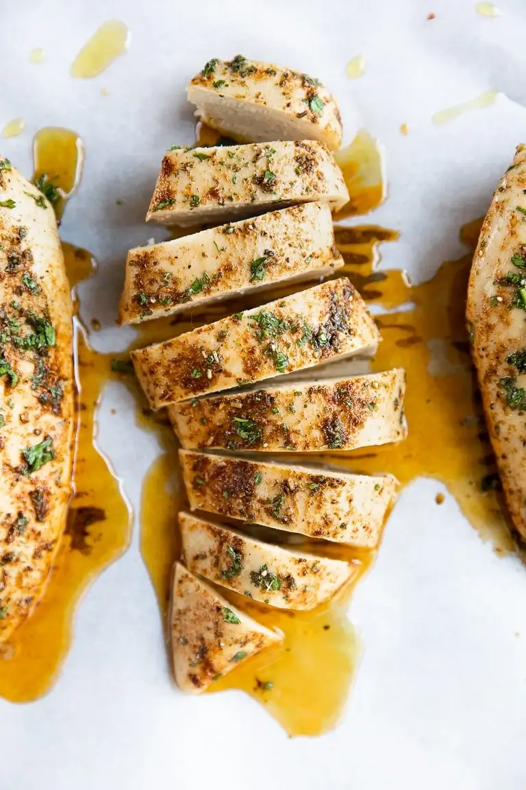Baked chicken breasts on white plate