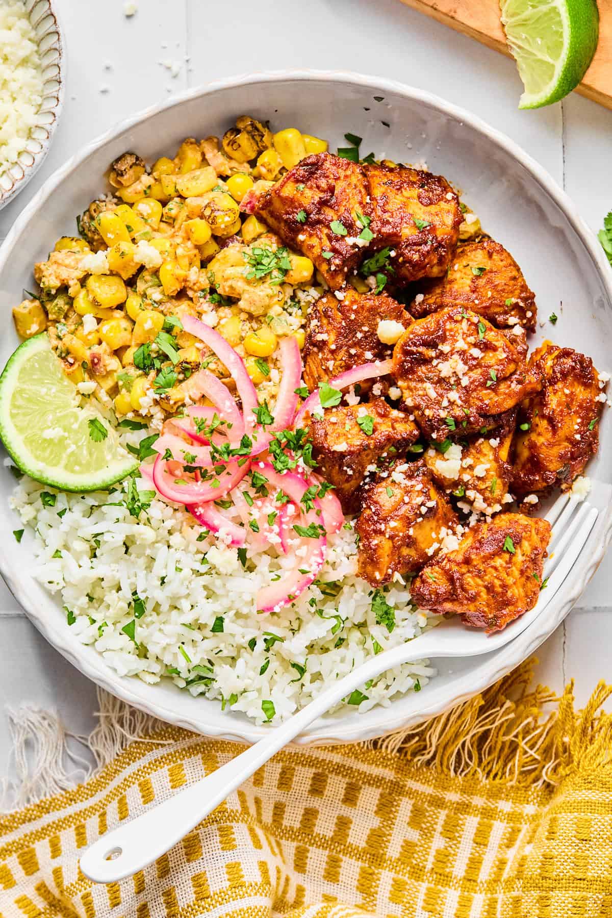 Street corn and chicken in white bowl