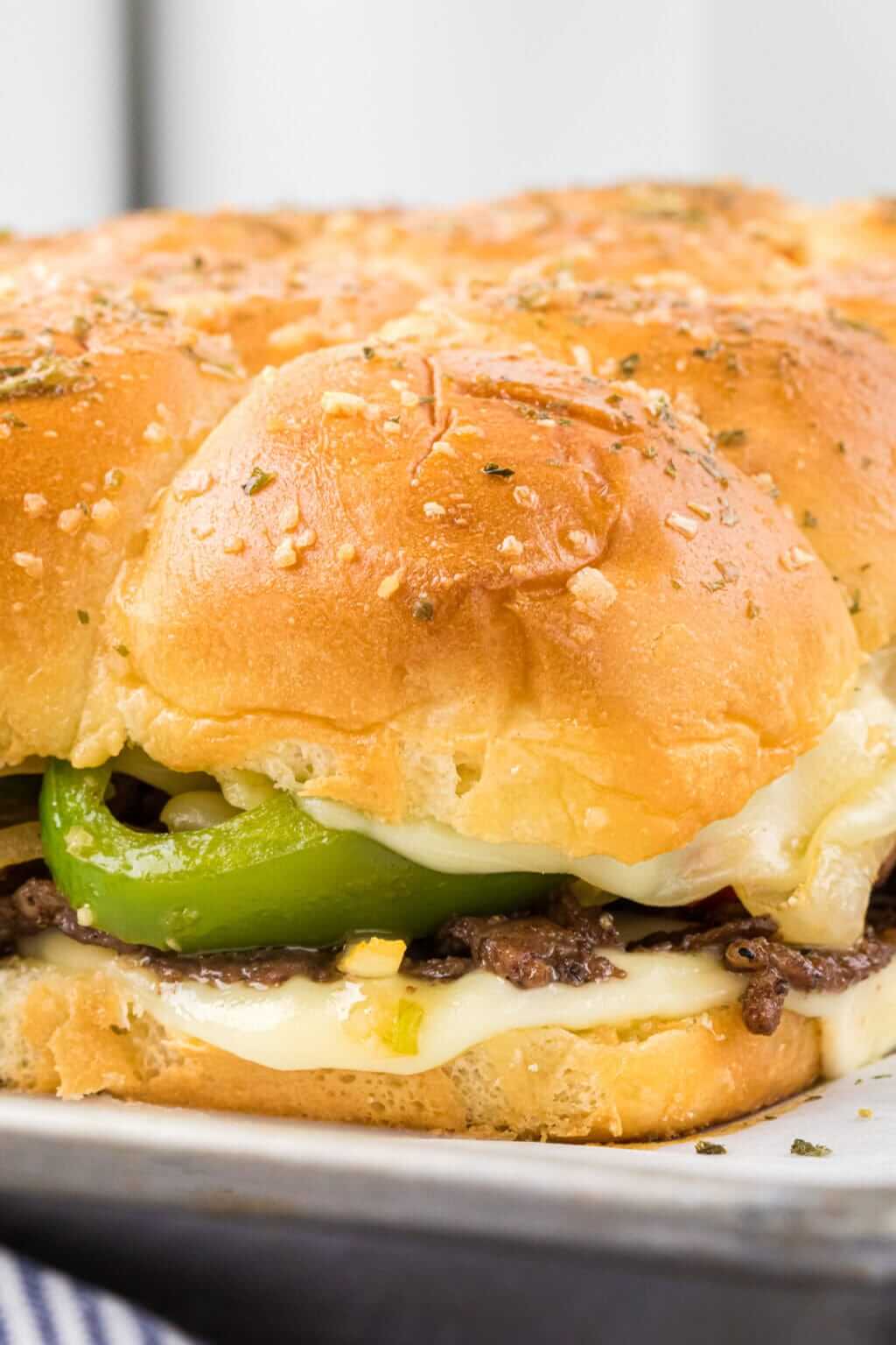 philly cheesesteak slider on white plate