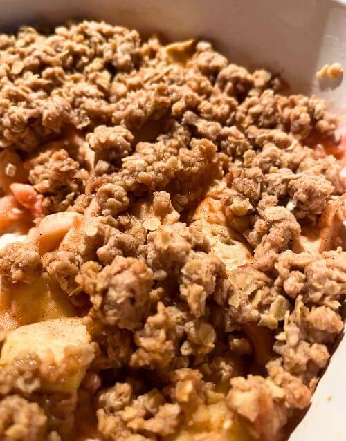 Apple crisp in white baking dish
