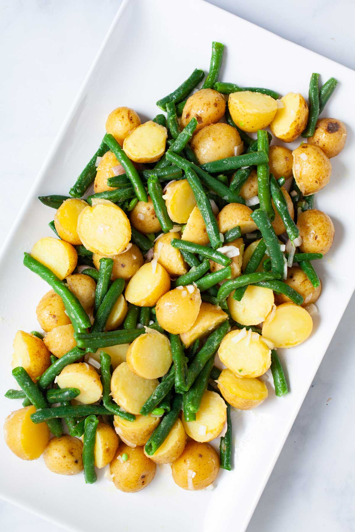Green beans and potatoes on white platter