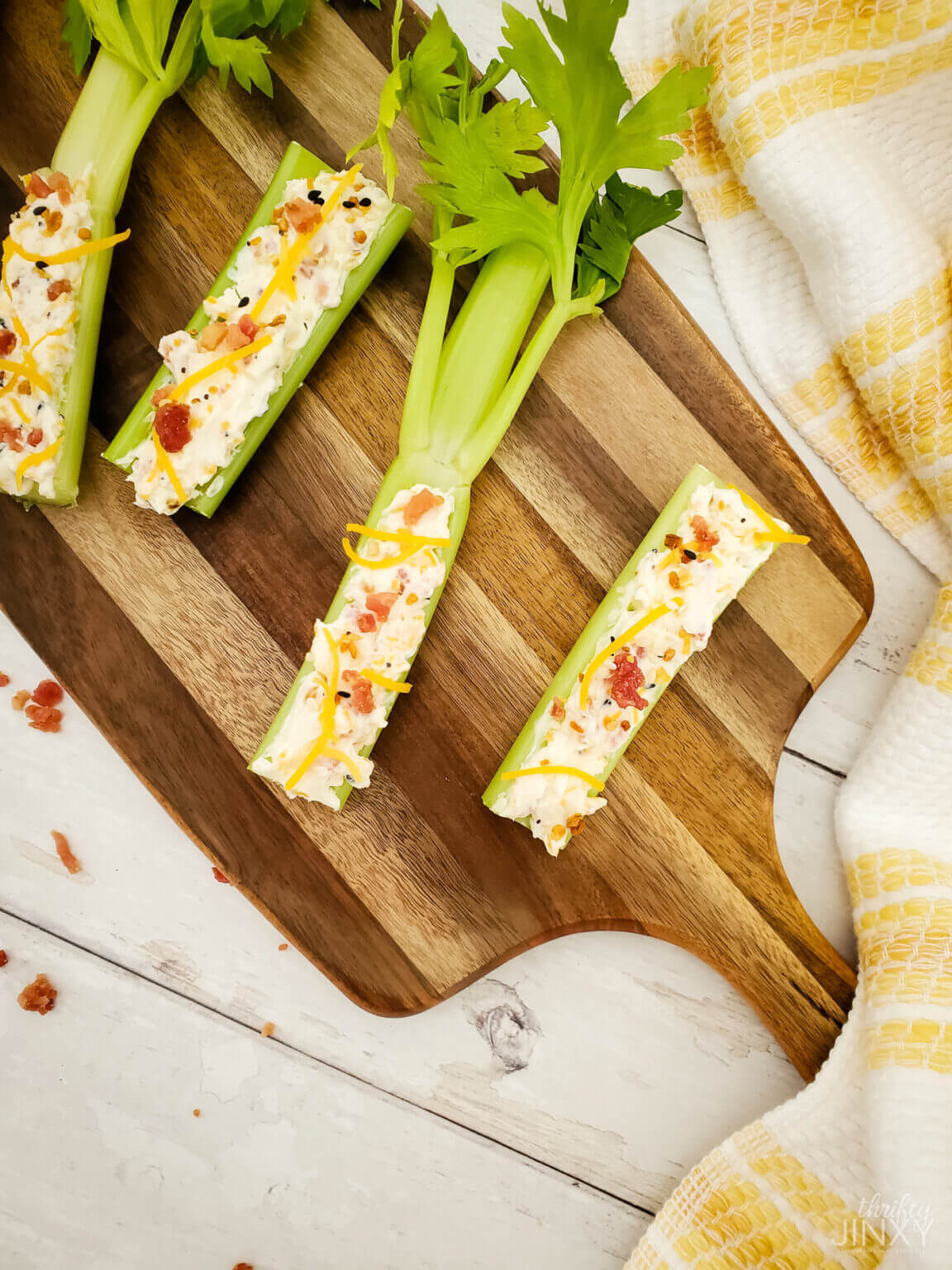 celery with cream cheese on wood board